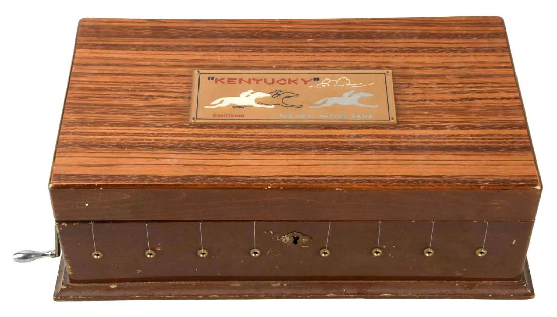 “The Kentucky” Horse Race Gambling Game.: Place the horse in the starting gate, turn the crank and the first horse of eight to reach the finish line wins the bet. (Excellent).