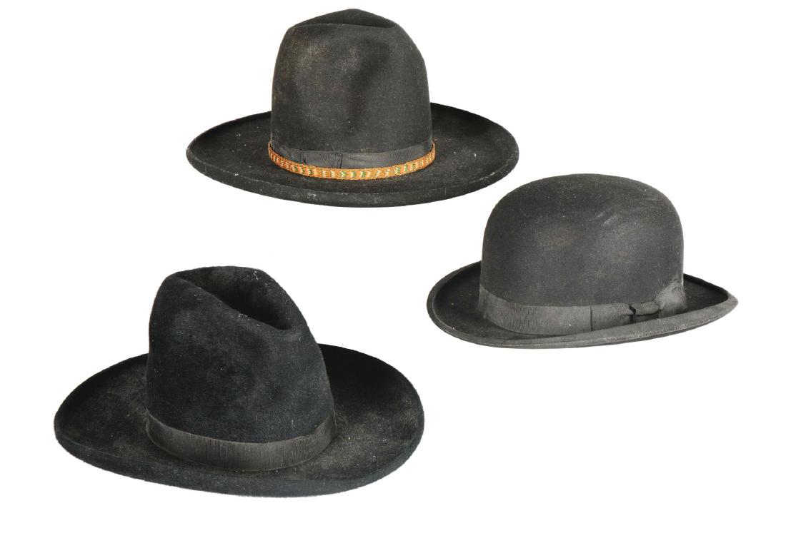 Lot Of 3: Cowboy and Bowler Hats.: Each of these three hats are made of black felt with Petersham ribbon bands. The bowler hat is marked "Franklin Simon Co., Fifth Ave, New York" and is dated around 1900. One of the two cowboy hats is 