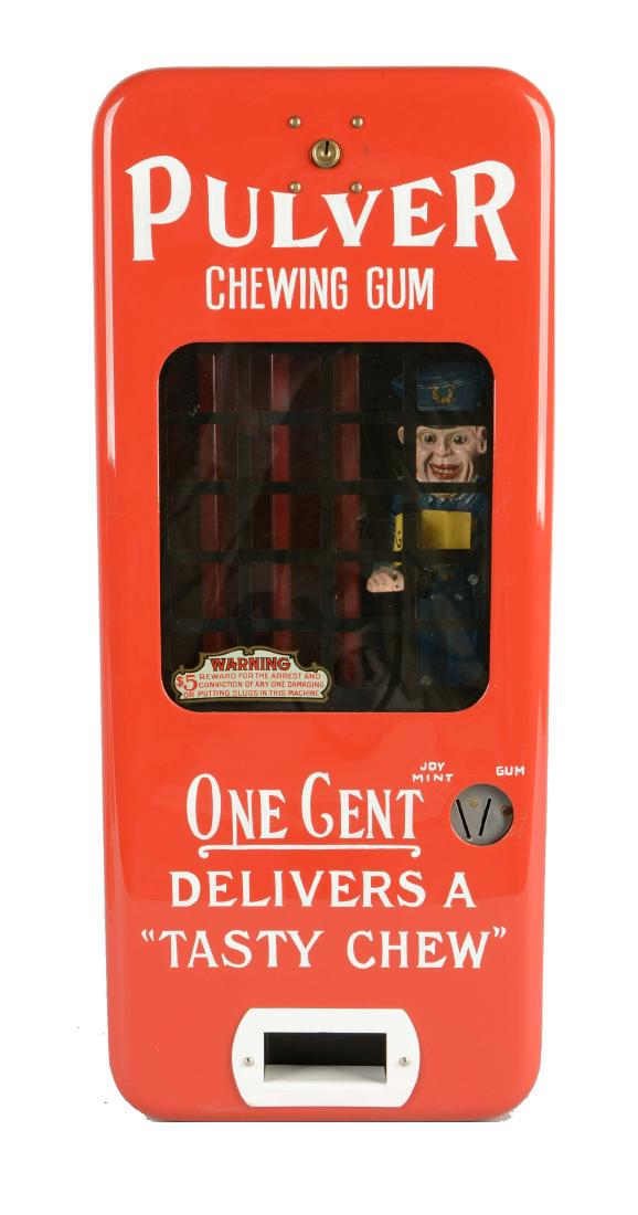 1¢ Pulver Too Choos Gum Vendor.: Bright cherry red porcelain gum vendor with white lettering and inner police officer figure. 20-1/2" T.