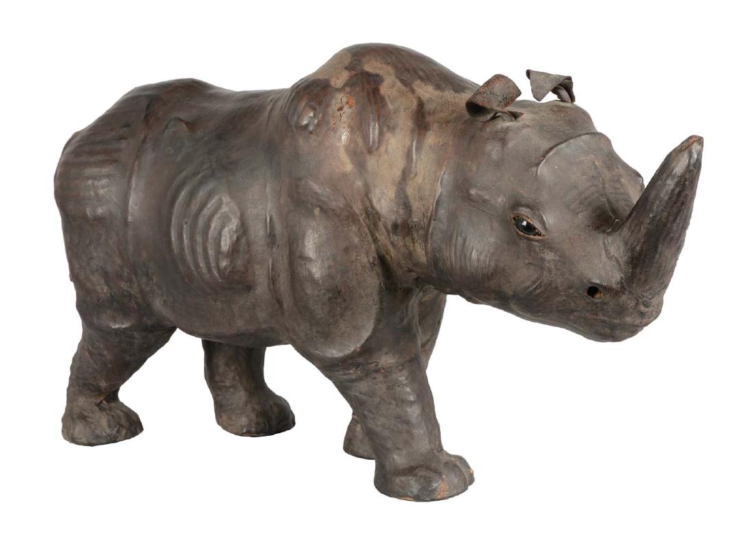 Vintage Leather Covered Rhinoceros.: Figural rhinoceros covered in leather. Tooled and detailed with glass eyes. A few scuffs are present. 12" x 16" x 32".