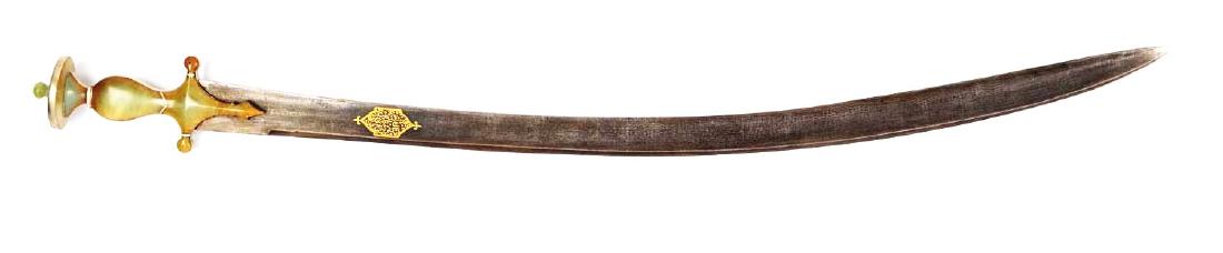 Rare Jade Hilted Tulwar.: The massive blade of fine, black Damascus steel inlaid with gold calligraphy in a cartouche. The silver bound hilt of mutton fat jade of classic Tulwar form. Condition of the blade is stained but over