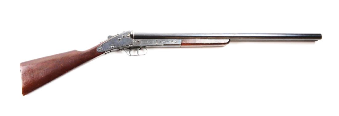 Daisy Model 104 SxS Shotgun.: Manufactured 1938 to 1940. Frame is engraved. Tubes are a replacement. Wood has usual dings. Double triggers. Excellent wood stocks with usual bumps and bruises. 90% blue on frame. 95% blue on replace