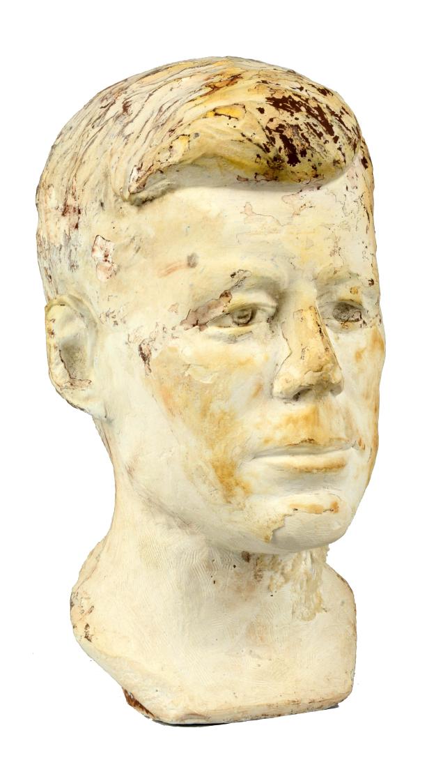 Plaster Bust of President Kennedy.: This lot consists of a plaster bust of President Kennedy. The artist has chosen to solely depict the face of the fallen President. Not only has he depicted Kennedy in a manner in which viewers are eas