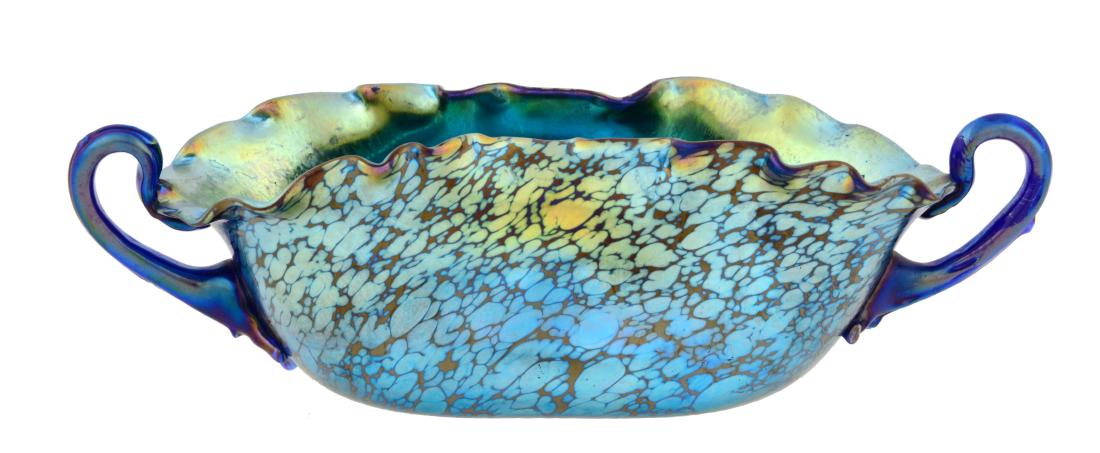 Loetz Cobalt Papillon Handled Bowl.: Loetz Cobalt Papillon Handled Bowl with Silberiris finish to interior. Small chip by handle. Condition: (Very Good).Dimensions: 12 - 1/4" L.