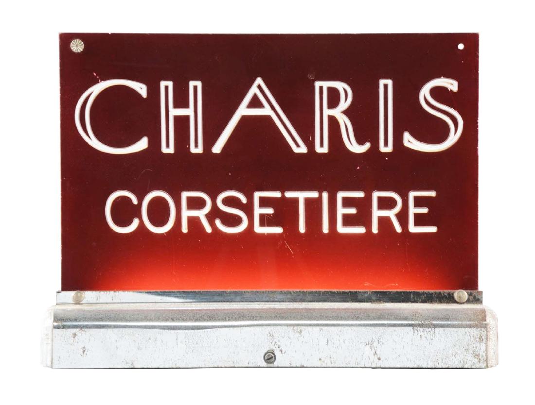 Charis Corsetiere Light Up Sign.: Plastic sign affixed to a metal base with some moderate soiling and oxidation to the base. Nice light up display in working order.Condition(Very Good).Dimensions13" x 9-1/2".