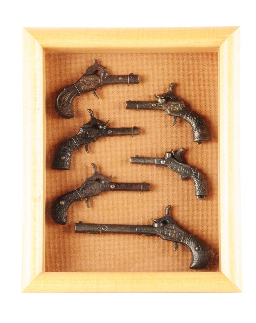 Lot of 6: Cast Iron Cap Guns.: Six cap guns made of cast iron from the late 1800's. Working condition.Condition:(Excellent).Dimensions:Largest: 5 - 3/4" L.