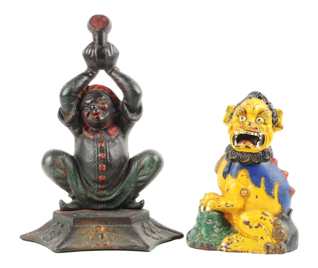 Lot of 2: Cast Iron Assorted Asian Doorstops.: Includes Chinese Jester. Two piece casting; and full-figure Foo Dog. Each book examples. Condition:(Excellent).Dimensions:Largest: 10 - 1/2" x 6 - 1/2".
