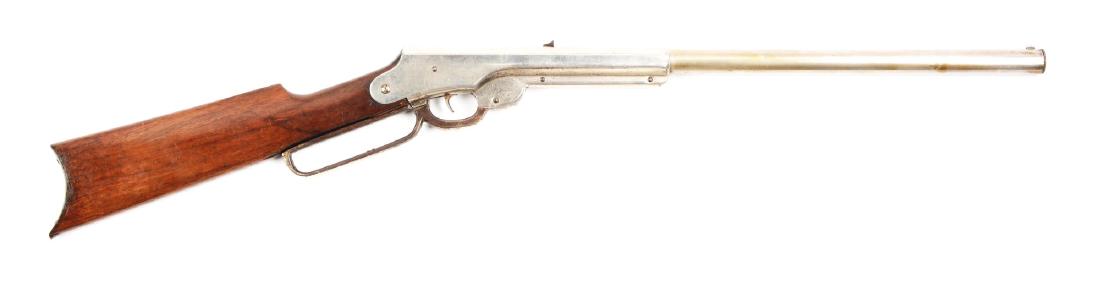 Daisy Bennett 1000 Shot Air Rifle: BB/.175 caliber, 1000 shot, Lever Action, Mfg. 1903-1909. 70% of original nickel finish remains with heay finish loss on lever. Stock has several knicks and bump marks. Steel buttplate. Lever does not