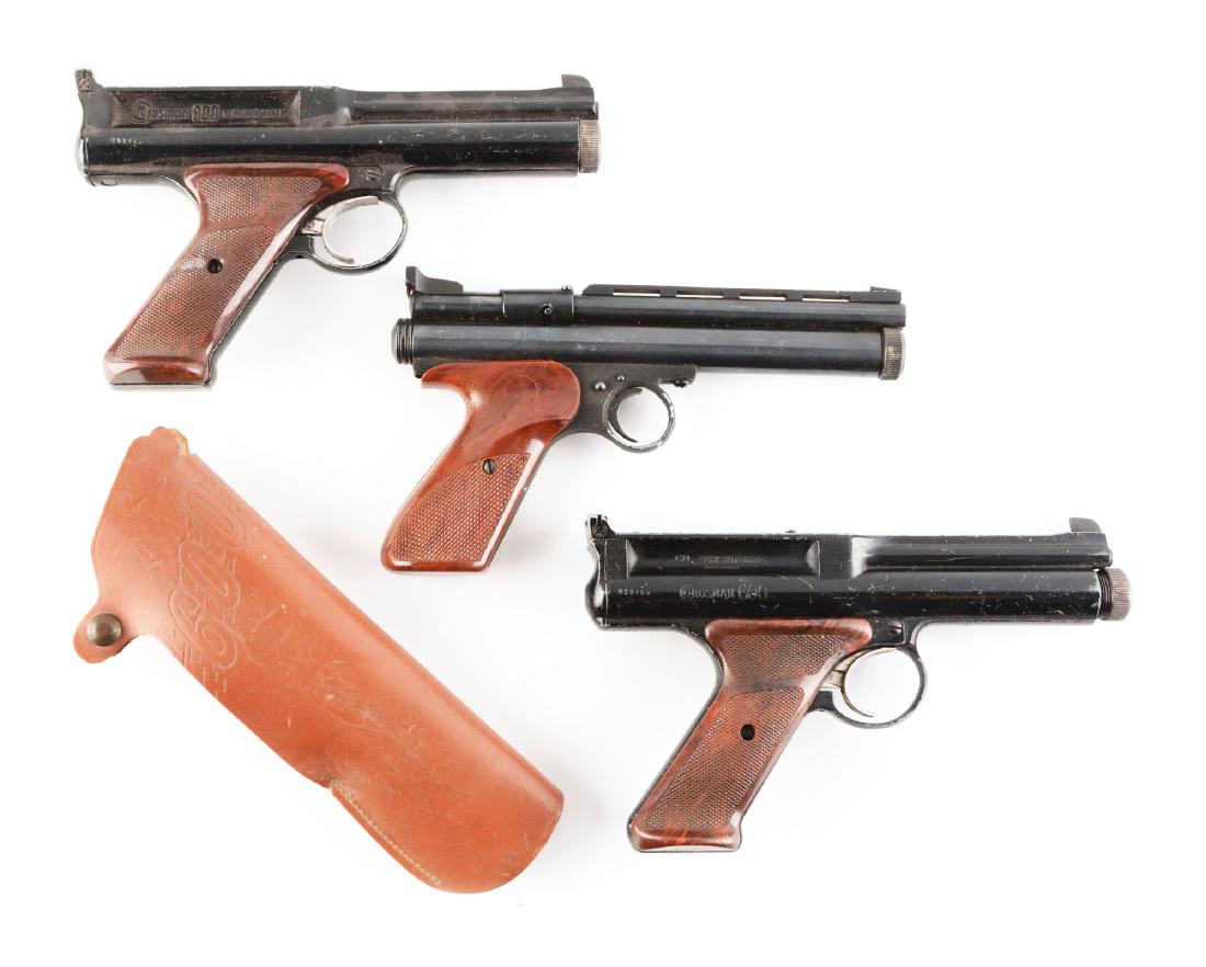 Lot Of 3: Crossman Air Pistols.: Include two 600's and one Ted Williams match pistol. (A) is a Crossman 600 in overall good condition with plastic grips with some residue on one side. Paint condition is at 85%. Gun is complete. Comes