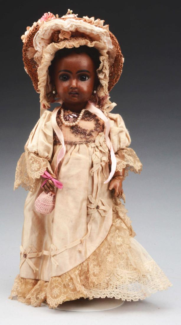 13” 1907 Brown Bisque Jumeau Child.: 13” doll with head incised “1907”, attributed to Jumeau, brown glass paper weight eyes, nicely painted lashes and brows, open mouth with red lips and four upper teeth, on the original fully join