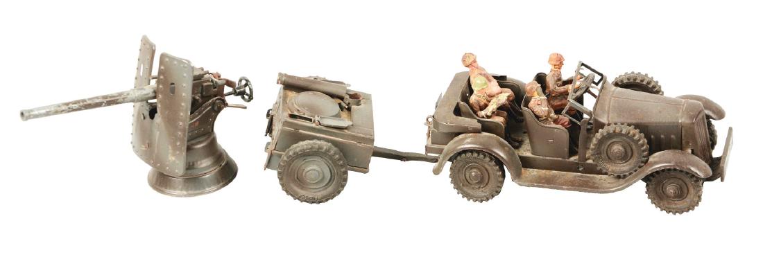 German Hausser Clockwork Tinplate Military Staff Car.: Comes with two side-mounted rubber tires marked "Hausser". Four composition figures; driver, map-reader, man holding rifle, and a passenger in saluting position. Marked "WH-733" on front and rear lice