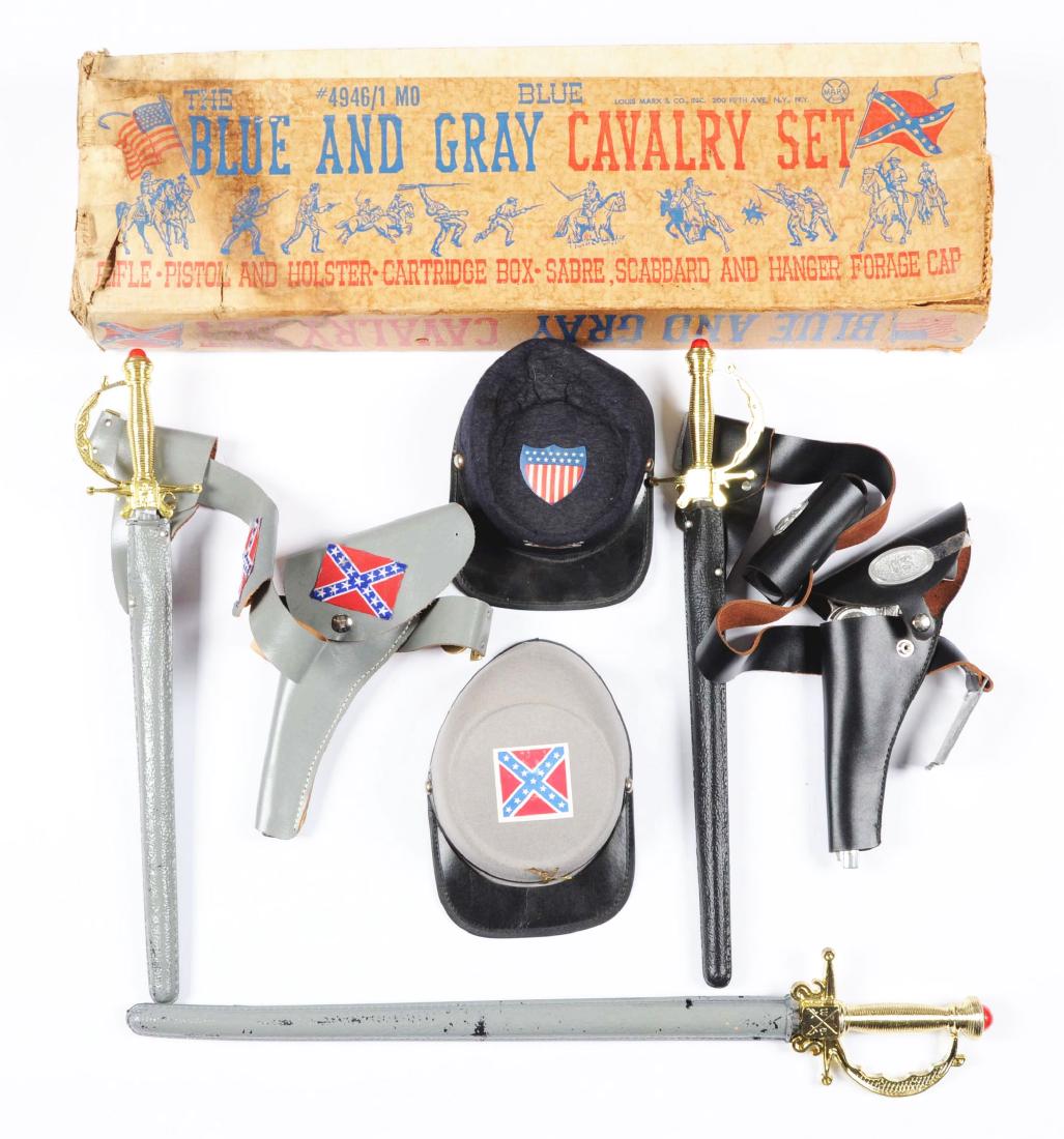 Scarce Marx Blue & Gray Calgary Set.: Includes original box that has some tearing, missing flaps and staining. Included are the Confederate and Union hats, Confederate and Union sabers and scabbards, an extra Confederate sword and scabbar