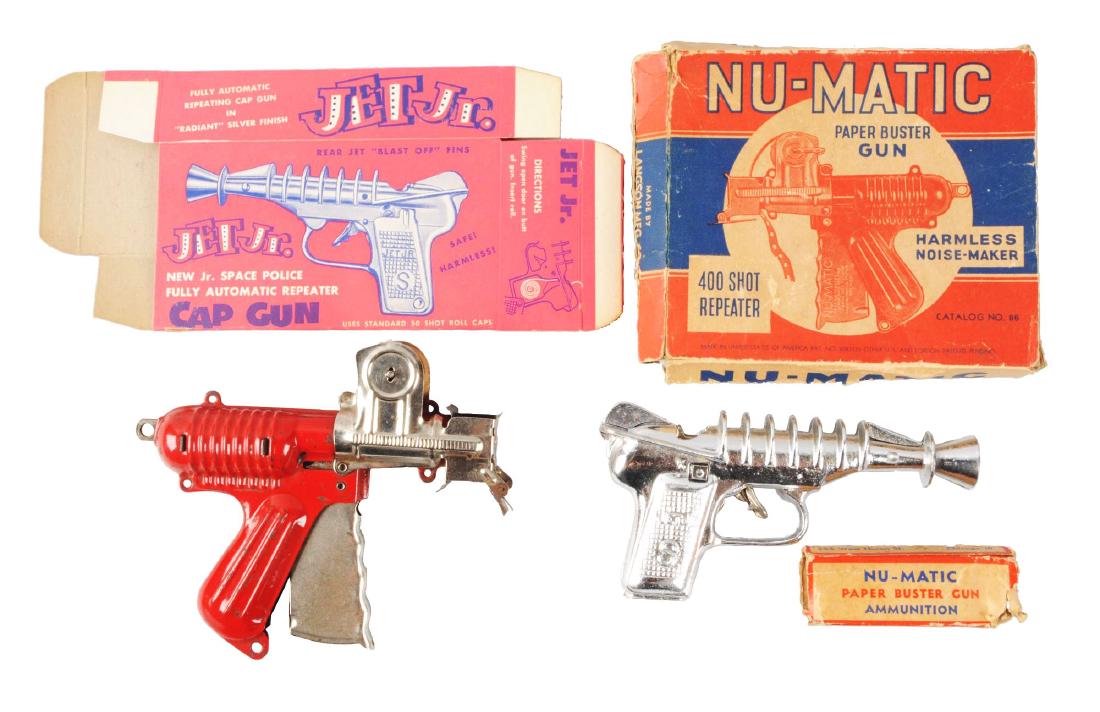 Lot Of 2: Scarce Metal & Cast Metal Toy Guns.: Both are in original boxes. One is a Langson Nu-Matic Paper Buster Gun which comes with some original paper caps inside. Box is missing some flaps and does have some creasing and wear. Gun has some sc