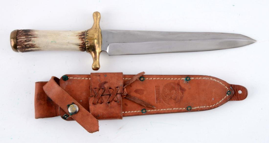 R.H. Ruana 42D Contemporary Bowie.: Saber ground spear point. Handled in genuine stag with heavy brass full guard and brass butt cap. Engraved "42D R.H. Ruana". Original sheath. Circa 1953 - 83.Blade Length: 9-3/4"Overall Length: 15-1/4