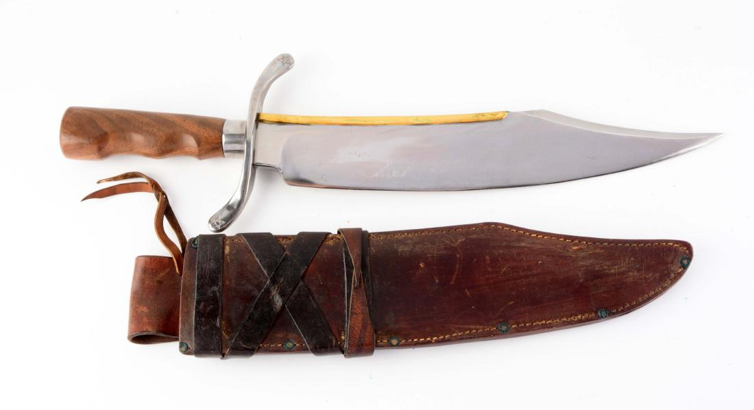 R.H. Ruana Contemporary Custom Bowie Signed on Brass: Brass back clip point blade. Handled in hardwood with heavy steel mount and large S-guard. Rare Ruana Bowie. Original leather sheath. Blade Length: 14-1/4"Overall Length: 20-1/4"