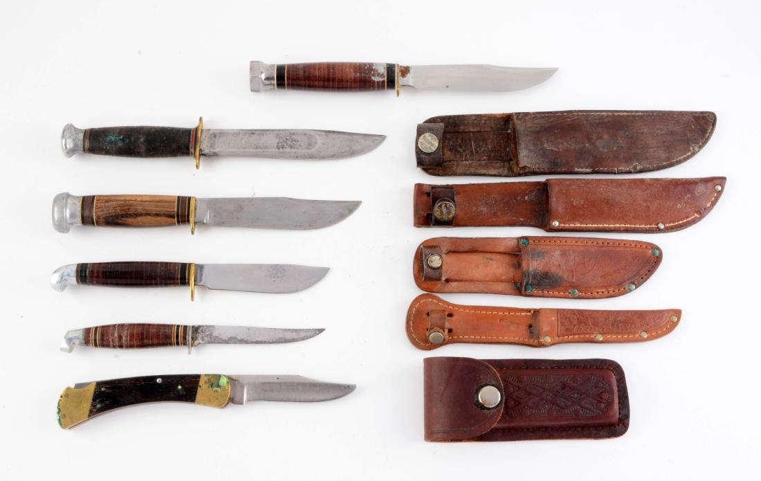 Lot of 6: Various Fixed Blade Knives.: Knife A) Marbles Ideal: Clip point blade with fullers. Stacked leather handle with aluminum crown and full brass guard. Correct leather sheath with signed safety snap. Knife B) Marbles Expert: Flat gr