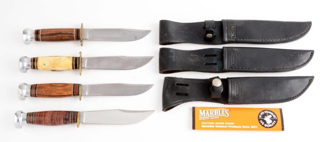 Lot of 4: Marbles Sheath Knives.: Knife A) Ideal clip point with fullers. Hardwood handle with aluminum crown and full brass guard. Correct leather sheath. In excellent condition. Circa late production. Knife B) Expert flat ground cli