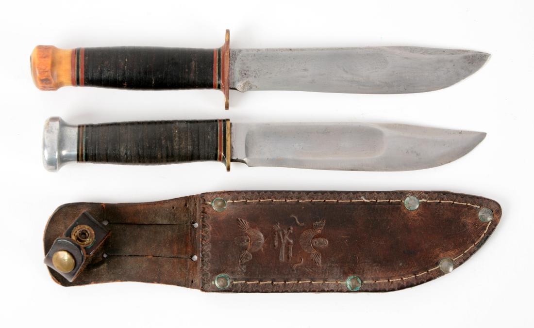 Lot of 2: Marbles Gladstone Mich. USA "Ideal" Sheath: Knife A) Clip point with fullers. Stacked leather handle with stag crown and brass full guard. No sheath. Circa post-1943. In good to very good condition. Knife B) Clip point with fullers. Stacked lea