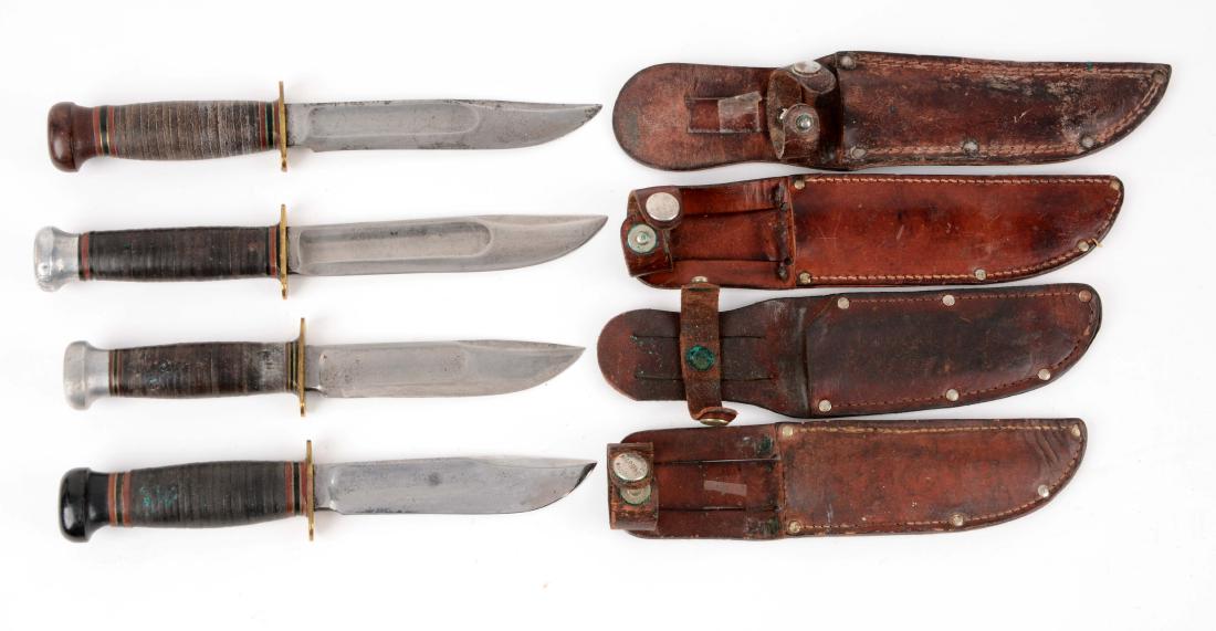 Lot of 4: Marbles Gladstone Mich. USA "Ideal" Fixed: Knife A) Clip point blade with fullers. Handled in stacked leather with lignum vitae. Correct sheath with signed safety snap. Circa post 1943. Condition: excellent. Knife B) Clip point with blade full