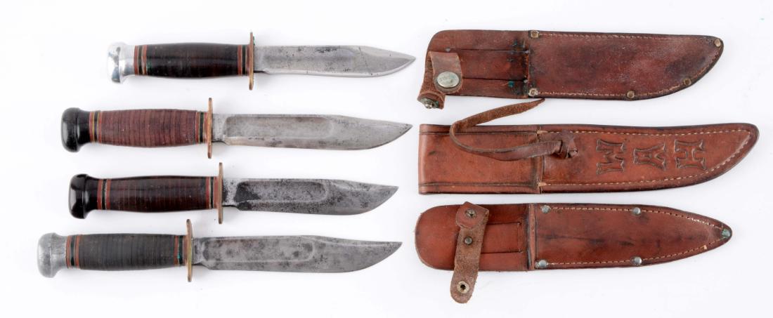 Lot of 4: Marbles Gladstone Mich. USA "Ideal" Fixed: Knife A) Clip point blade with fullers. Handled in stacked leather with aluminum crown and brass full guard. Correct leather sheath with signed safety snap. Circa post 1943. Knife B) Clip point blade