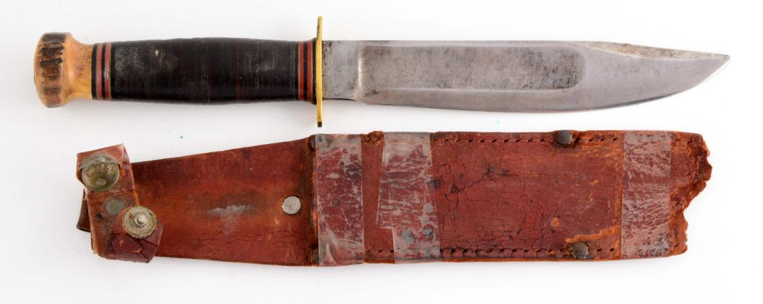 Marbles Gladstone Mich. USA "Ideal" Sheath Knife.: Clip point with fullers. Stacked leather handle with genuine stag crown and full brass guard. Incorrect leather sheath in fragmented condition. Circa post-1943.Blade Length: 6-3/4"Overall Length: 11-1