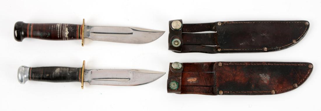 Lot of 2: Marbles Gladstone Mich. USA "Ideal" Sheath: Knife A) Clip point with fullers. Stacked leather handle with full brass guard and lignum vitae crown. Correct leather sheath & signed safety snap. Circa post-1943. Knife B) Clip point with fullers. S