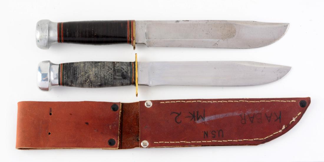 Lot of 2: Marbles Gladstone Mich. USA "Ideal" Sheath: Knife A) Clip point with fullers. Handled in stacked leather with aluminum crown and full brass guard. No sheath. Circa post 1943. In good to very good condition. Knife B) Clip point with fullers. Han