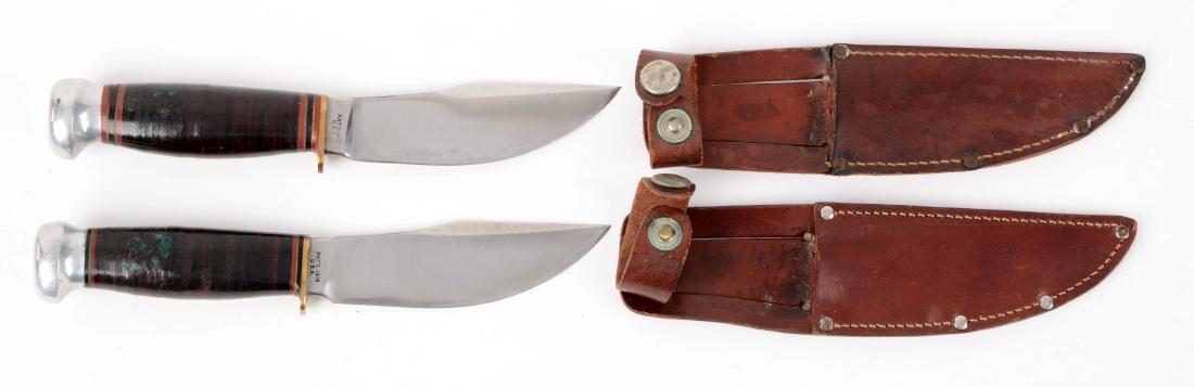 Lot of 2: Marbles Gladstone Mich. USA "Wood Craft": Knife A) Skinning blade with thumb grooved back. Handled in stacked leather with aluminum crown and brass half guard. Correct sheath with signed safety snap. Circa pre 1943. Knife B) Skinning blade wi