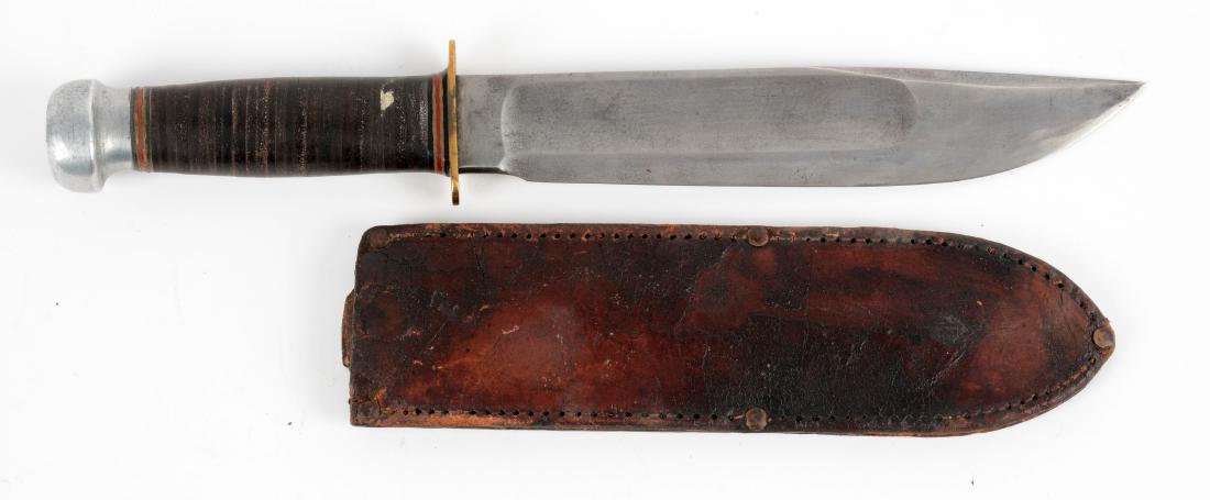 Marbles Gladstone Mich. USA "Ideal".: Clip point with fullers. Stacked leather handle with aluminum crown and brass full guard. Damaged Marbles sheath with top half missing. Condition of knife is Excellent.Blade Length: 8"Overall Length: