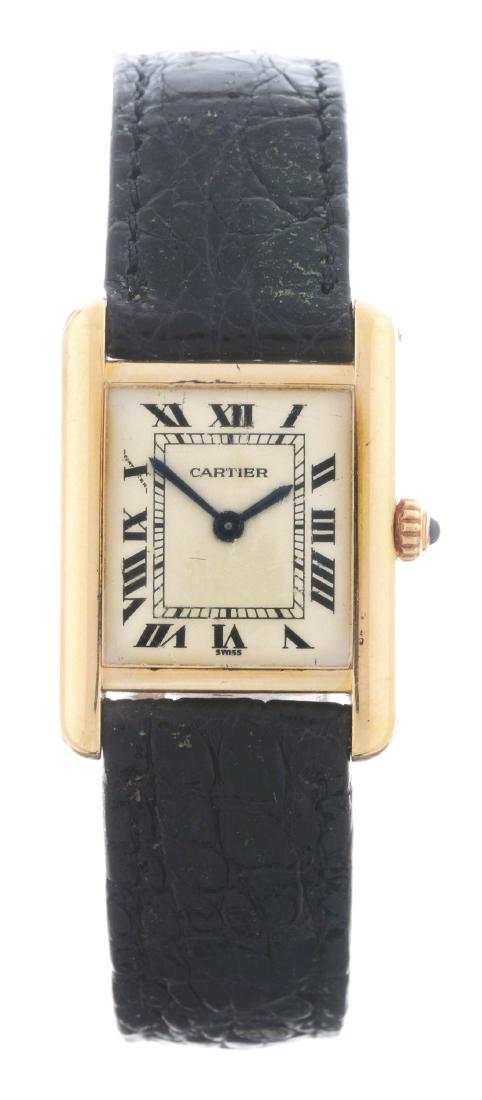Cartier 18k Yellow Gold Tank Quartz on Strap: Cartier 18k Yellow Gold Tank Quartz on Strap. 21mm case diameter. Signed Cartier stop. Unmarked buckle. Sets and runs. Circa 1990. Overall condition is excellent. Wear to case. Clean strap.