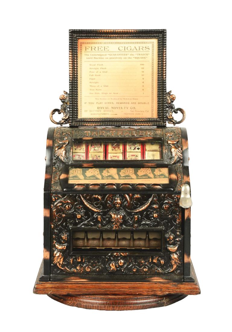 **5 & 10¢ Royal Novelty Co. Trader Cigar Trade: Circa 1902. Retains its original marquee and paper insert with old replacement cards. This is a very ornate machine with a great copper flash finish. Machine is on a swivel base. One original key is i