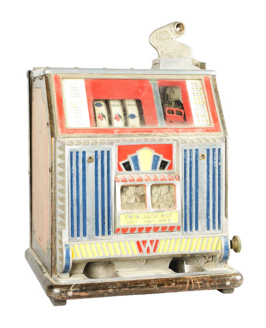 **10¢ Watling Baby Bell Twin Jackpot Slot Machine.: Three-reel gooseneck bell slot machine with two-toned wood cabinet and decorative front castings and lower vendor. Wear and scratches are present throughout. With mismatched reel strips and original p