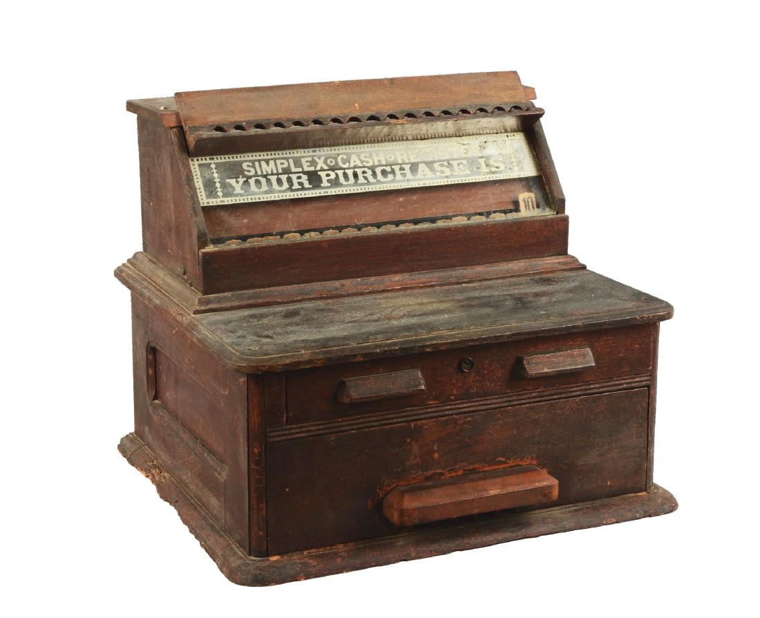 Wooden Simplex Cash Register.: Constructed of wood with the values set behind glass. The silver marquee reads "Simplex Cash Register. Your Purchase Is". The bottom drawer remains locked while the top drawer contains wooden beads, s