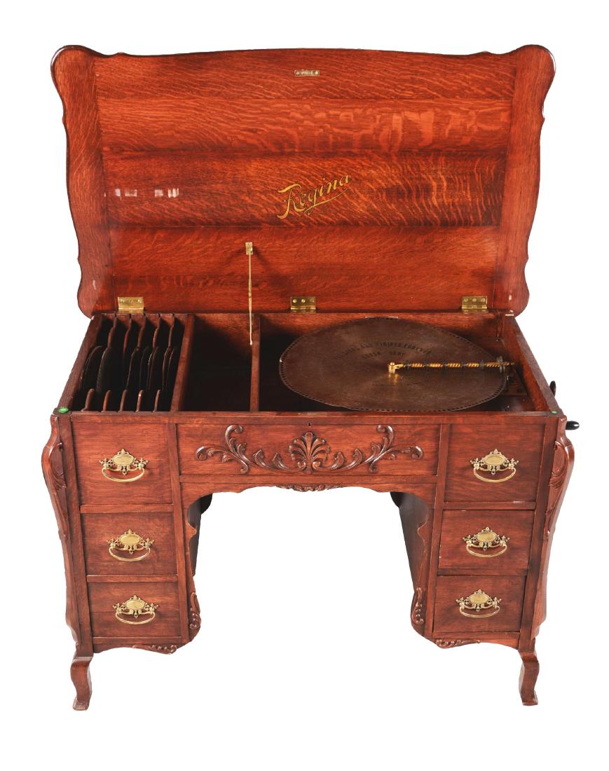 Regina Reginaphone No.161 Music Box Desk With Discs.: Made of quarter sawn oak with gold Victorian handles with filigree carved motifs at center and on the sides. Only two of the three right side drawers open with a storage compartment for the discs on t