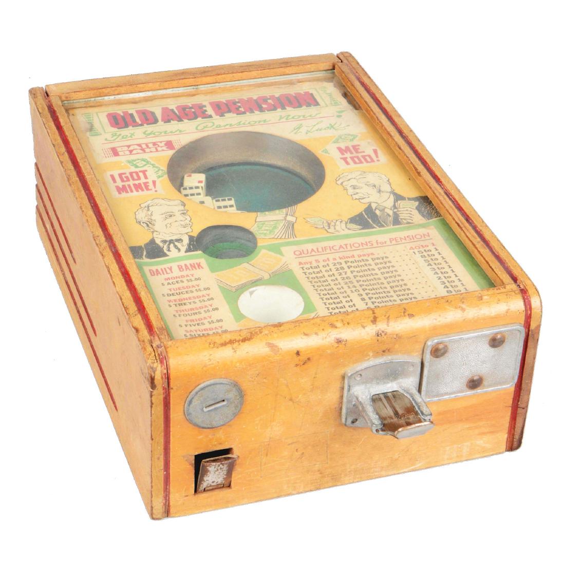 **5¢ Exhibit Supply "Old Age Pension" Dice Trade: Manufactured in 1927 by The Exhibit Supply Co., this device shows wear throughout the wood with the interior paper decal exhibiting some damage found along the edges and some staining. However, the di
