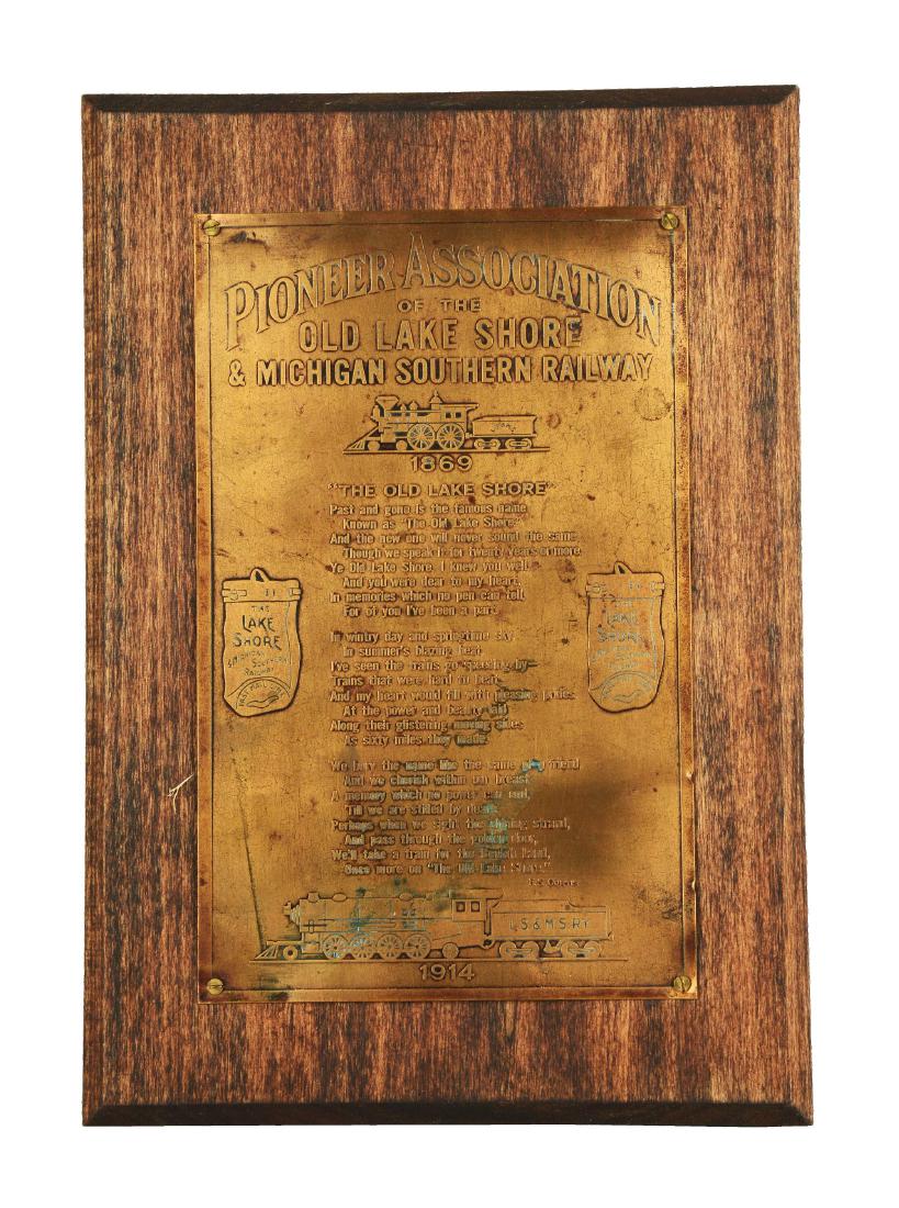 Old Lake Shore Railway Plaque.: Wooden plaque with inscribed brass, that fully reads "Pioneer Association Of The Old Lake Shore & Michigan Southern Railway" across the top, sitting above a single train cart. A long poem, titled "The