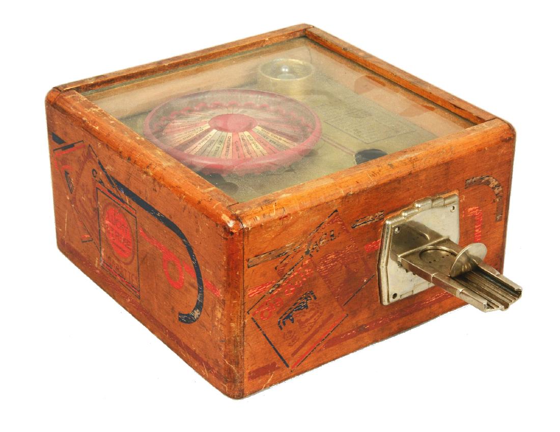 **1¢ Star Mfg. Square Shooter Trade Stimulator.: This countertop trade stimulator is similar in design to a roulette wheel but has three balls instead of one. If players spun three of a kind they won packs of cigarettes. Worn throughout and requires
