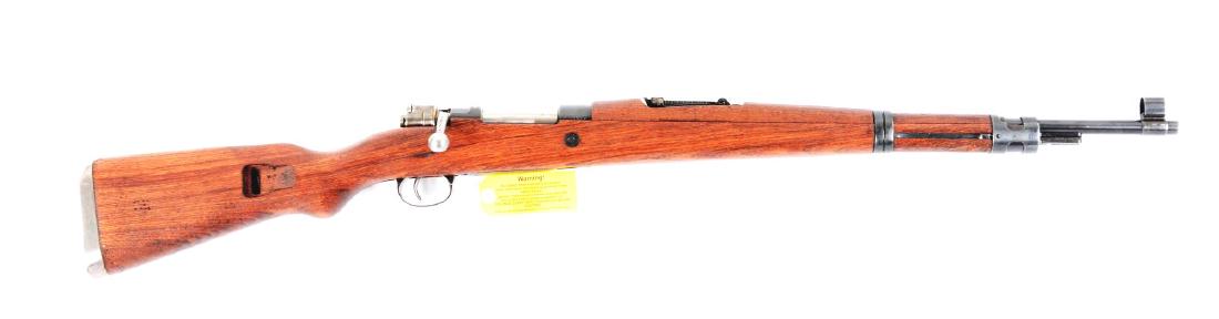 (C) Boxed Yugoslavian Mauser Model 48 Bolt Action: Features round blue barrel with ramp front and adjustable rear sight. Mauser style bolt action with national crest. Hardwood military stock with upper hand guard and bayonet lug. Safety on rear of the