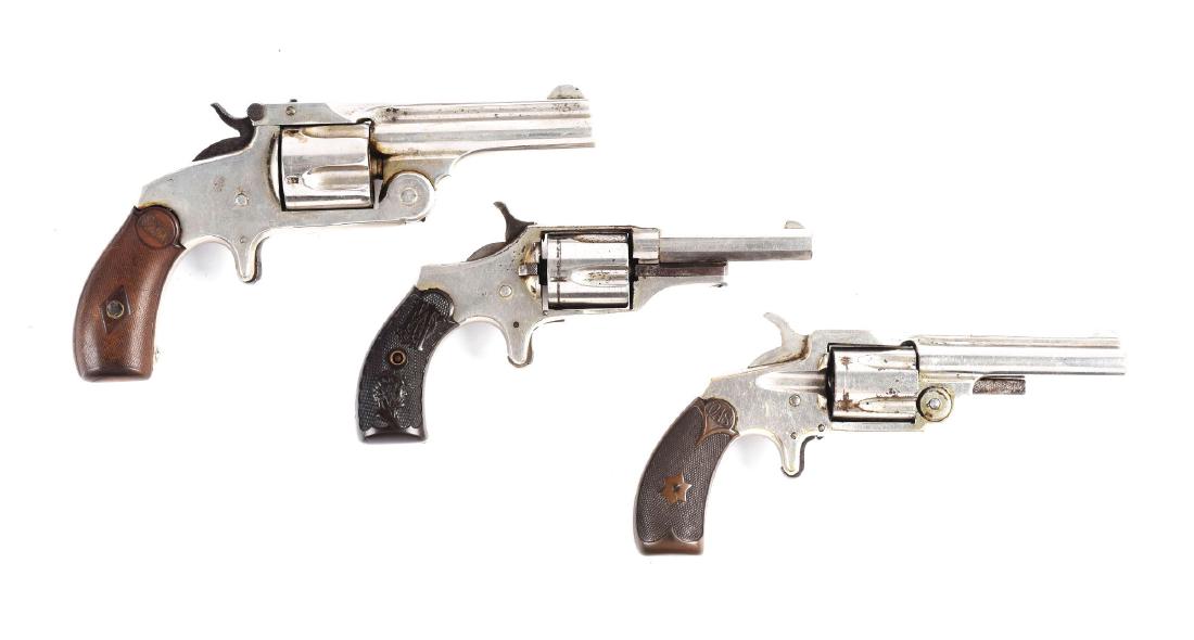 (A) Lot of 3: Antique Spur Trigger Revolvers.: Gun (A) .38 single action Second Model manufactured 1877 to 1891. Features round barrel with rib, spur trigger, top break, single action, nickel finish, and Smith & Wesson logo black composite grips.