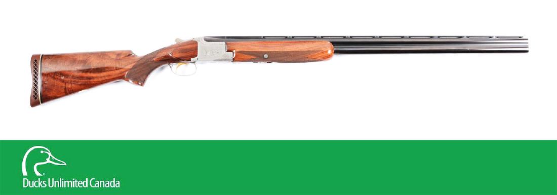 (C^) Cased Belgian Browning Pigeon Grade Superposed 12: Manufactured in 1961. Round blued superposed barrels with wide vented matte rib with twin white beads. Boxlock actions with French grey finish and pigeon grade engraving, including scrolls and two pig