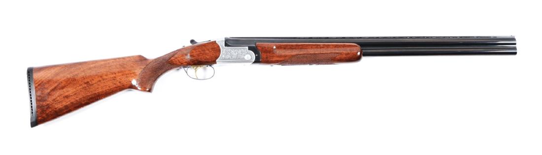 (M) Cased American Arms Over and Under Boxlock Shotgun.: Manufactured in Spain in 1985. Blued barrels with vented matte rib and single brass bead. Stainless steel scalloped boxlock action with crossbar and scroll engraving. Features include ejectors, single