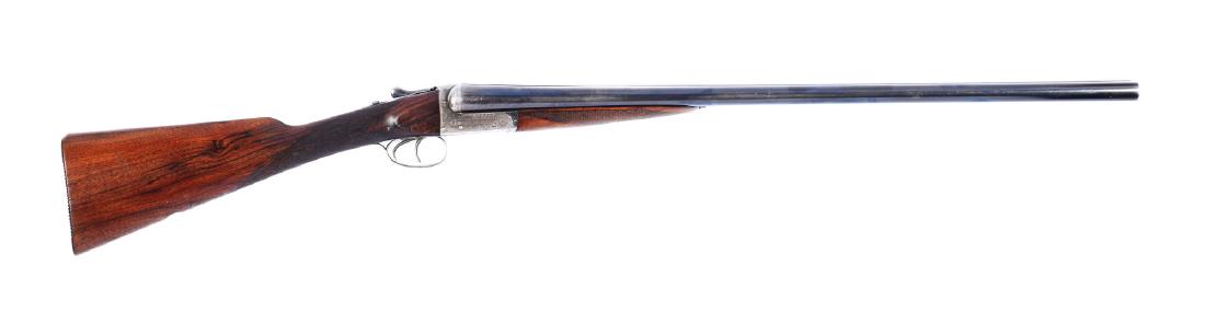 (C^) English Boxlock Double Barrel Shotgun by Webley &: Round blued steel barrels with solid rib, marked near breeches "WEBLEY & SCOTT LTD/LONDON & BIRMINGHAM". Boxlock action engraved with detailed English scrolls and marked "WEBLEY & SCOTT LTD" on both s