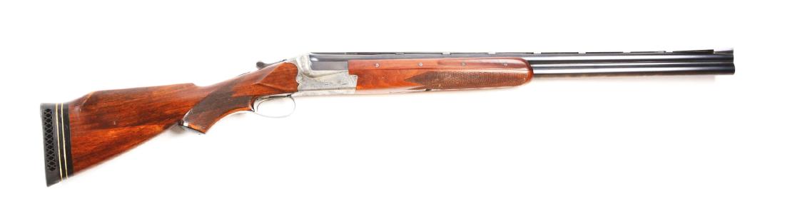 (C^) Merkel Model 200E Over and Under 12 Bore Boxlock: Blued barrels marked on left side of breech "GEBRUDER MERKEL/SUHL" with matte rib flared at muzzle, large silver bead and small white bead. Case hardened scalloped boxlock action with areas of scroll 