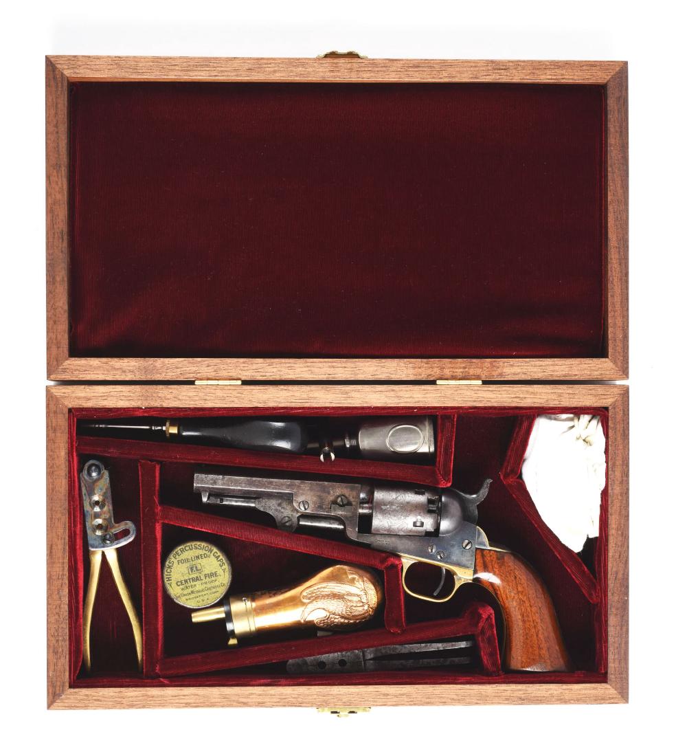 (A) Cased Colt Model 1849 Percussion Pocket Revolver.: Standard features; octagon barrel, cylinder has very strong stage coach scene, five-shot, single action, percussion with nickel plated guard and back strap and one piece varnished walnut grips. This i