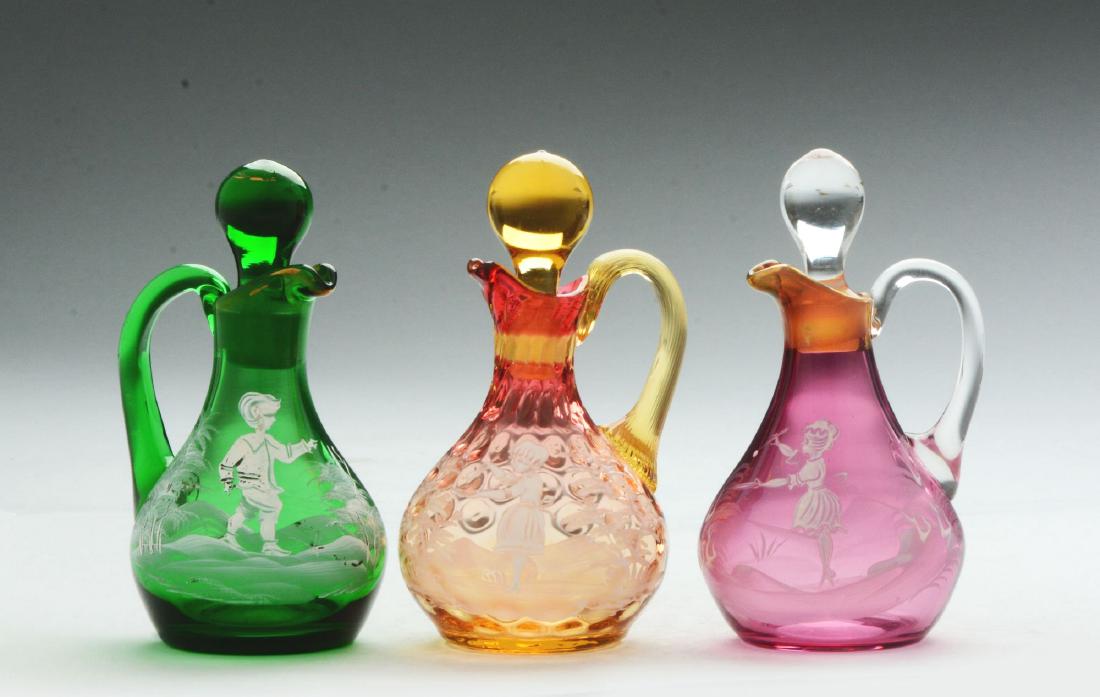 Lot of 3: Mary Gregory Cruets.: Includes cruets in green, pink and orange glass.Condition:(Near Mint Plus).Dimensions:Each: 6 - 1/2" T.