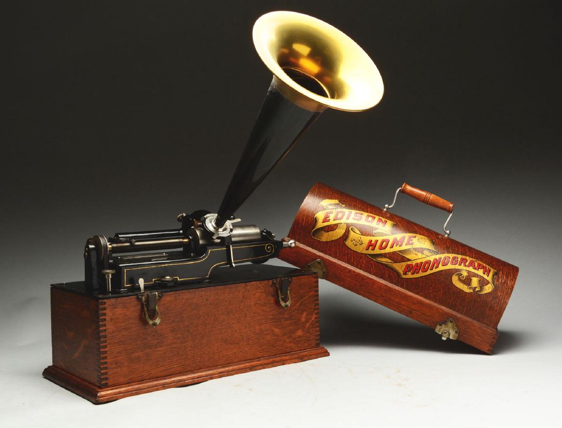 Edison Home Phonograph.: This lot consists of an Edison home phonograph. It appears to be complete and has a case with a horn. Overall the piece is in good condition with normal wear present.Condition:(Very Good - Excellent).