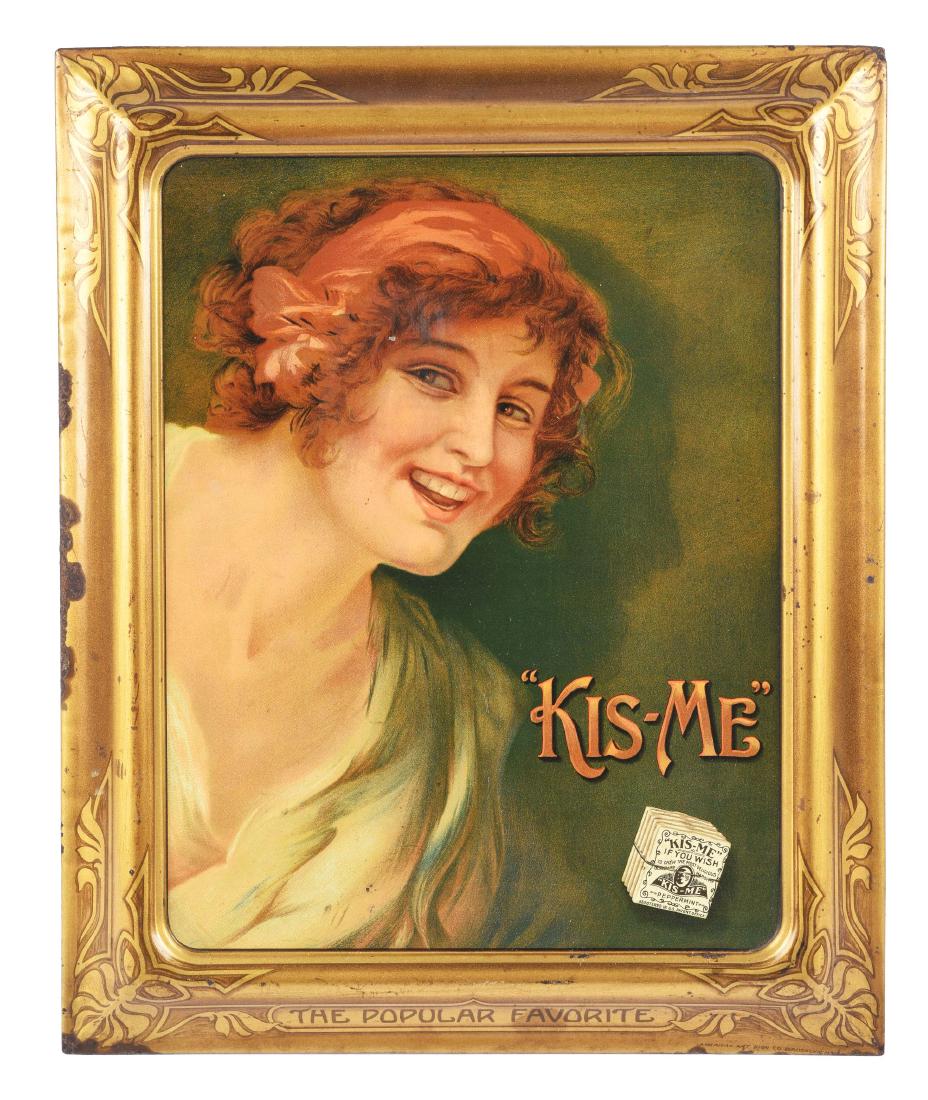 Kis-Me Gum Self-Framed Tin Sign.: Nice image of a lady leaning over a pack of Kis-Me gum. Nice color with some wear to the gold frame. Condition:(Excellent).Dimensions16 - 3/4" x 13 - 3/4".Condition:(Excellent).Dimensions16 - 3/4" x 1