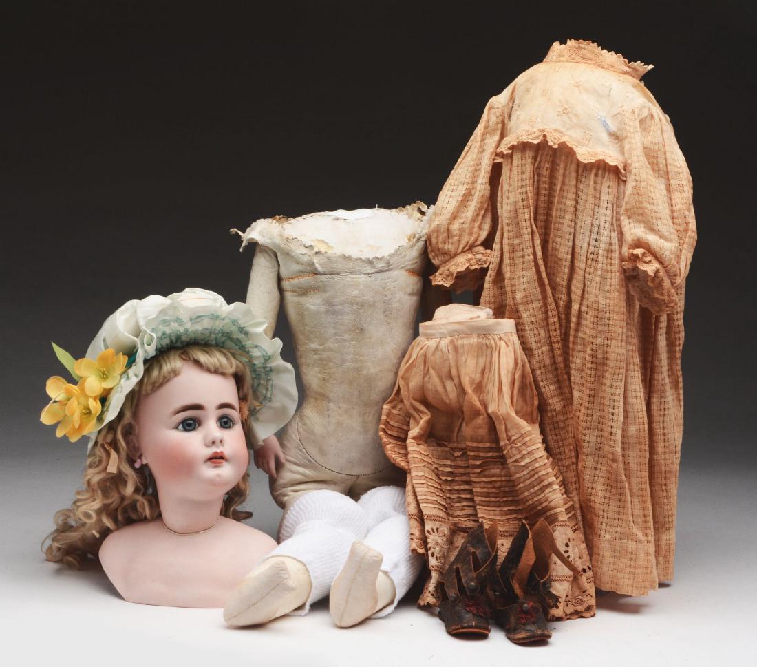 German Simon & Halbig Open Mouth 949.: Larger child on kid body with bisque lower arms. Body has curving to legs and detachment of lower legs from upper legs. Shoulder plate and head are intact and appear to be free of damage. Blue glass s