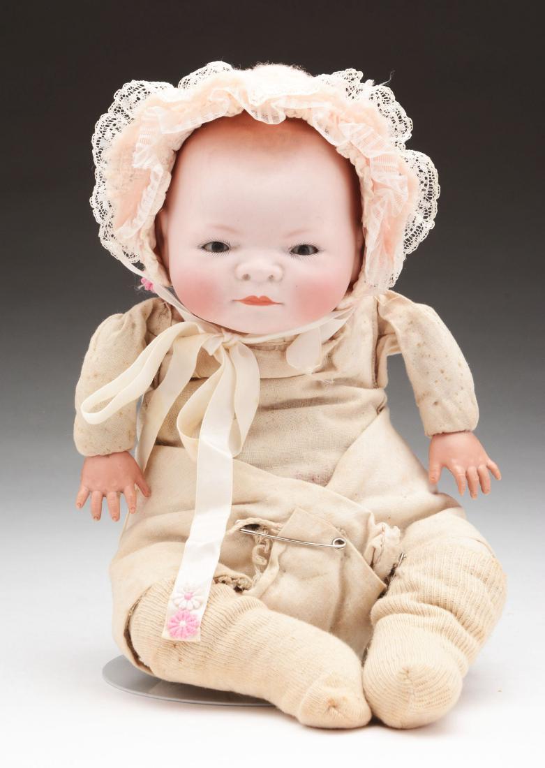 14" Bye-Lo Baby.: A nice brown eyed Bye-Lo baby on the typical frog leg cloth body with celluloid hands. Rear of head is marked "Grace Storey Putnam". She is dressed in appropriate clothing. There is no damage to the b