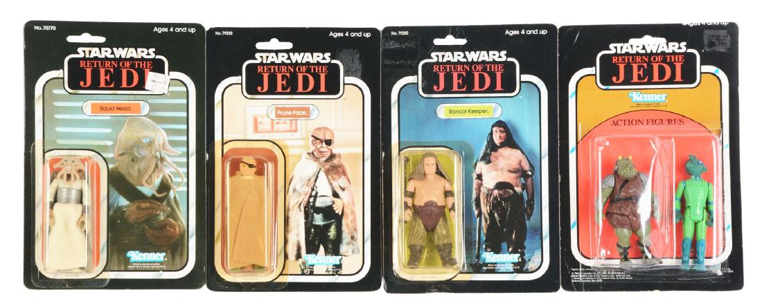 Lot of 4: Star Wars Return of The Jedi Figures.: Lot includes: Prune Face, Squid Head, Rancor Keeper, and a two pack Greedo and Gamorean Guards. All are on original cards. Dimensions: Each Box: 10 - 1/2" x 7". Condition: (Excellent - Excellent Plus)
